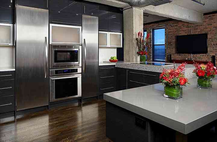Modern L-Shaped Kitchen Design With Seamless High Gloss Finish And Elegant Herringbone Backsplash