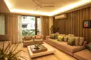 Modern Living Room Design With An L-Shaped Beige Tufted Sofa