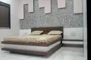 Modern Bedroom Design With A Brown Bed And Motif Wallpaper For The Bed Back Wall