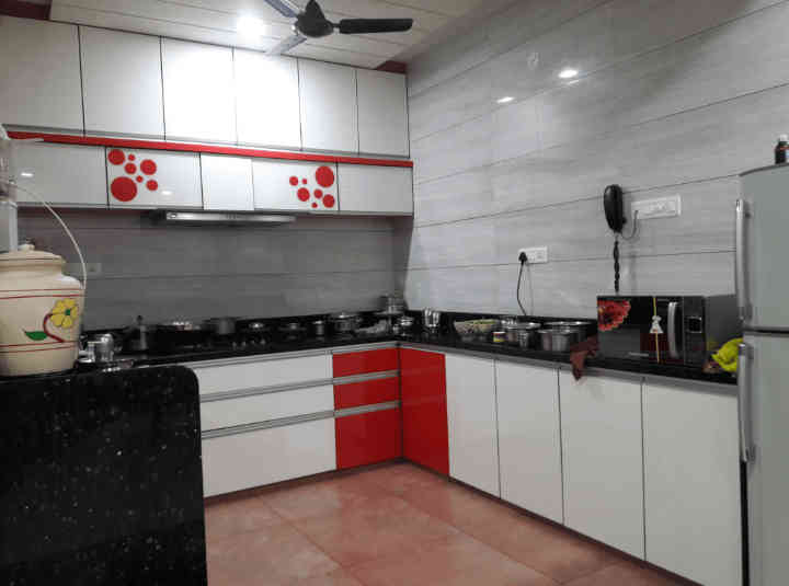 Small L-Shaped Modular Kitchen Design With Red and White Cabinets