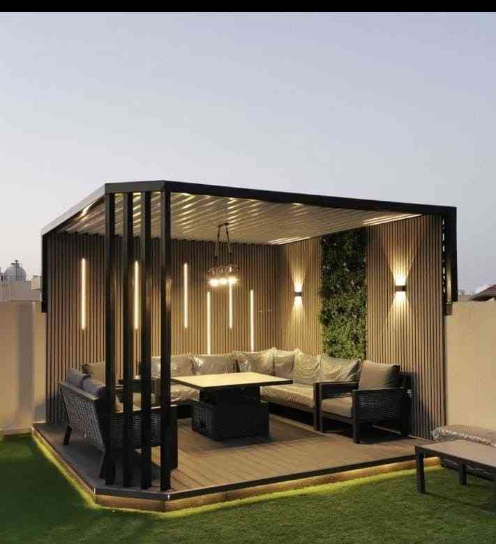 A Chic And Cozy Outdoor Lounge With Modern Lighting