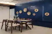 Contemporary 4-Seater Dining Room Setup With Navy Blue Wall