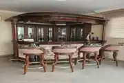 Luxurious Vintage Home Bar with Ornate Wooden Detailing and Elegant Bar Stools