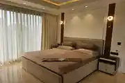 Elegant Modern Bedroom with Neutral Tones and Soft Ambient Lighting