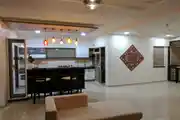 Indian Kitchen Design with Colorful Lighting and Cozy Bar Area