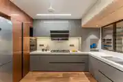 Sleek Modular Kitchen Design with Glossy Cabinets and Wood Finish Flooring
