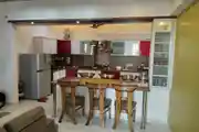Open Modular Kitchen With Dining Table And Chairs