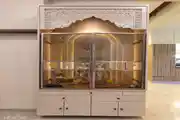Elegant Pooja Unit with Intricate Carvings and Ambient Lighting