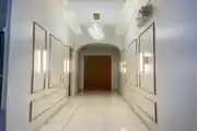 Elegant Hallway With Modern Lighting And Gold-Trimmed Wall Panels