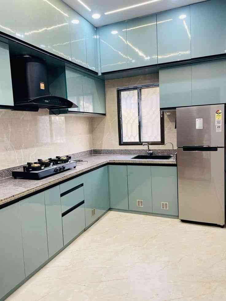 Sleek And Modern Modular Kitchen Design With Glossy Aqua Blue Cabinets