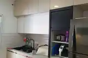 Well-Organized And Modern Kitchen Setup Featuring Glossy Cabinets
