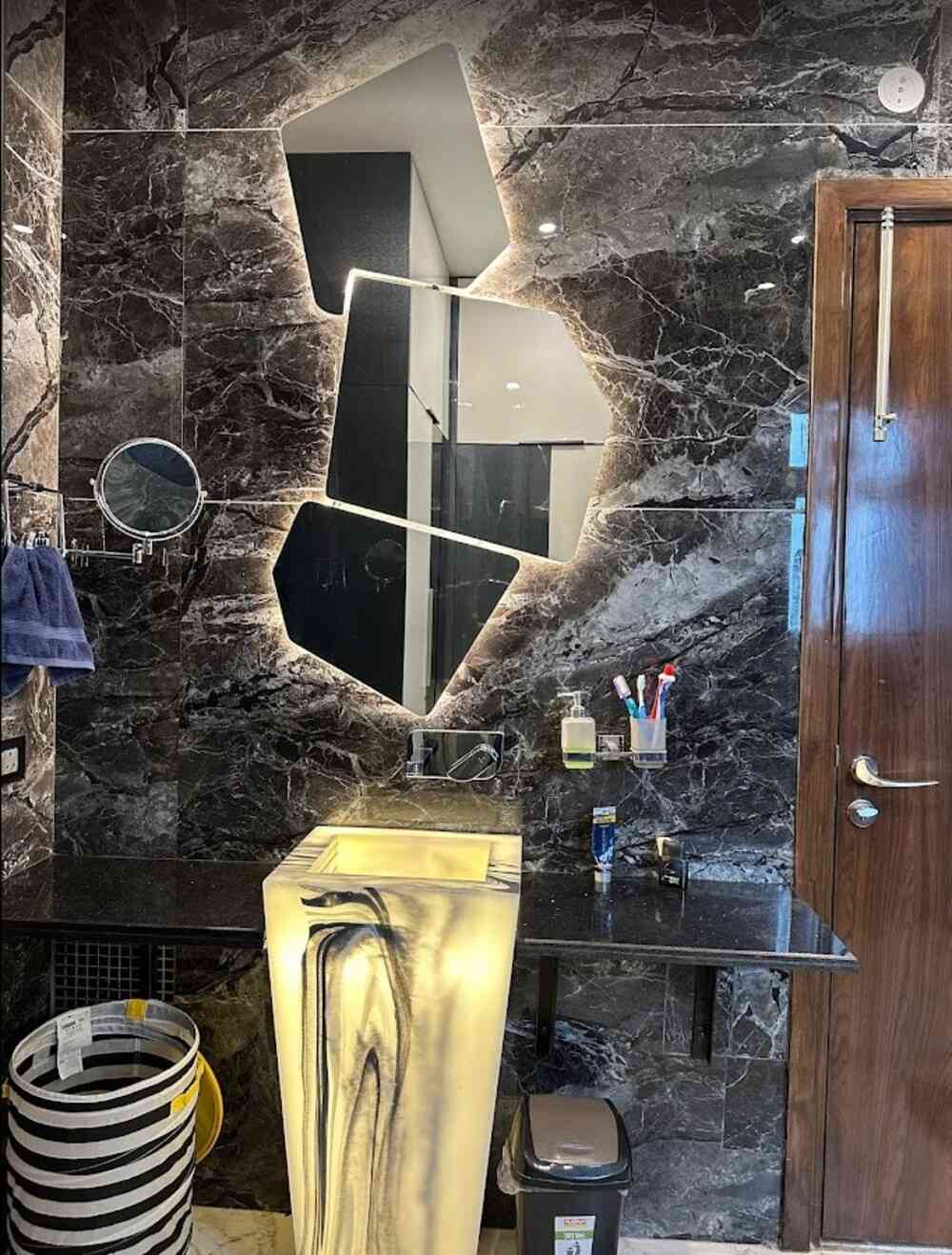 Modern Bathroom Design Featuring Asymmetrical Backlit Mirrors