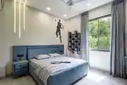 Vibrant Bedroom Blends Soft Tones With Modern Lighting And Playful Decor