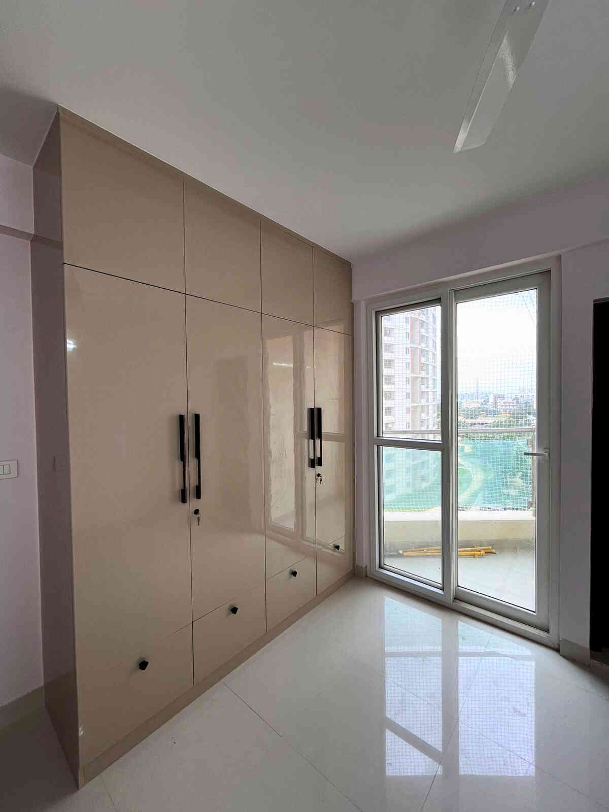 Sleek And Modern Bedroom Wardrobe Design With Glossy Beige Finish
