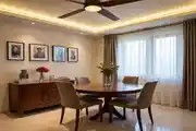 Cozy And Elegant Dining Area With A Round Wooden Table