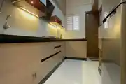 Sleek And Functional Modular Kitchen Featuring Glossy Cabinets